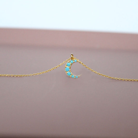 Tiny moon crescent with turquoise cubic zirconia